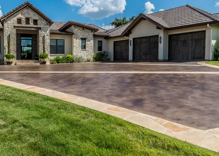 Decorative concrete driveway in front of a beautiful house