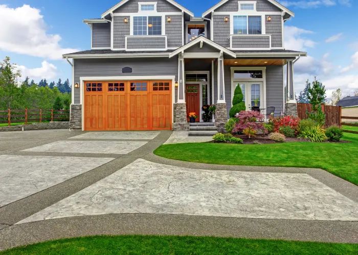 A beautiful decorative driveway in front of a newer craftsman styled house
